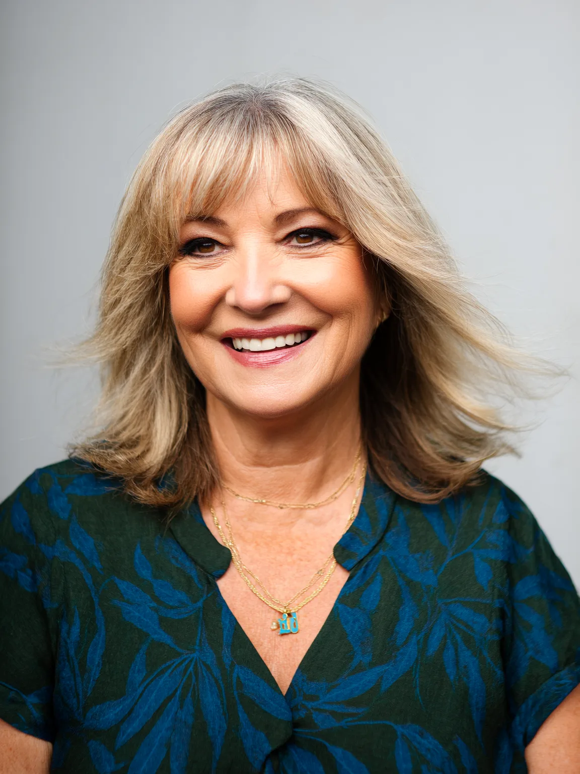 Shoulder-Length Wavy Layers with Wispy Curtain Bangs